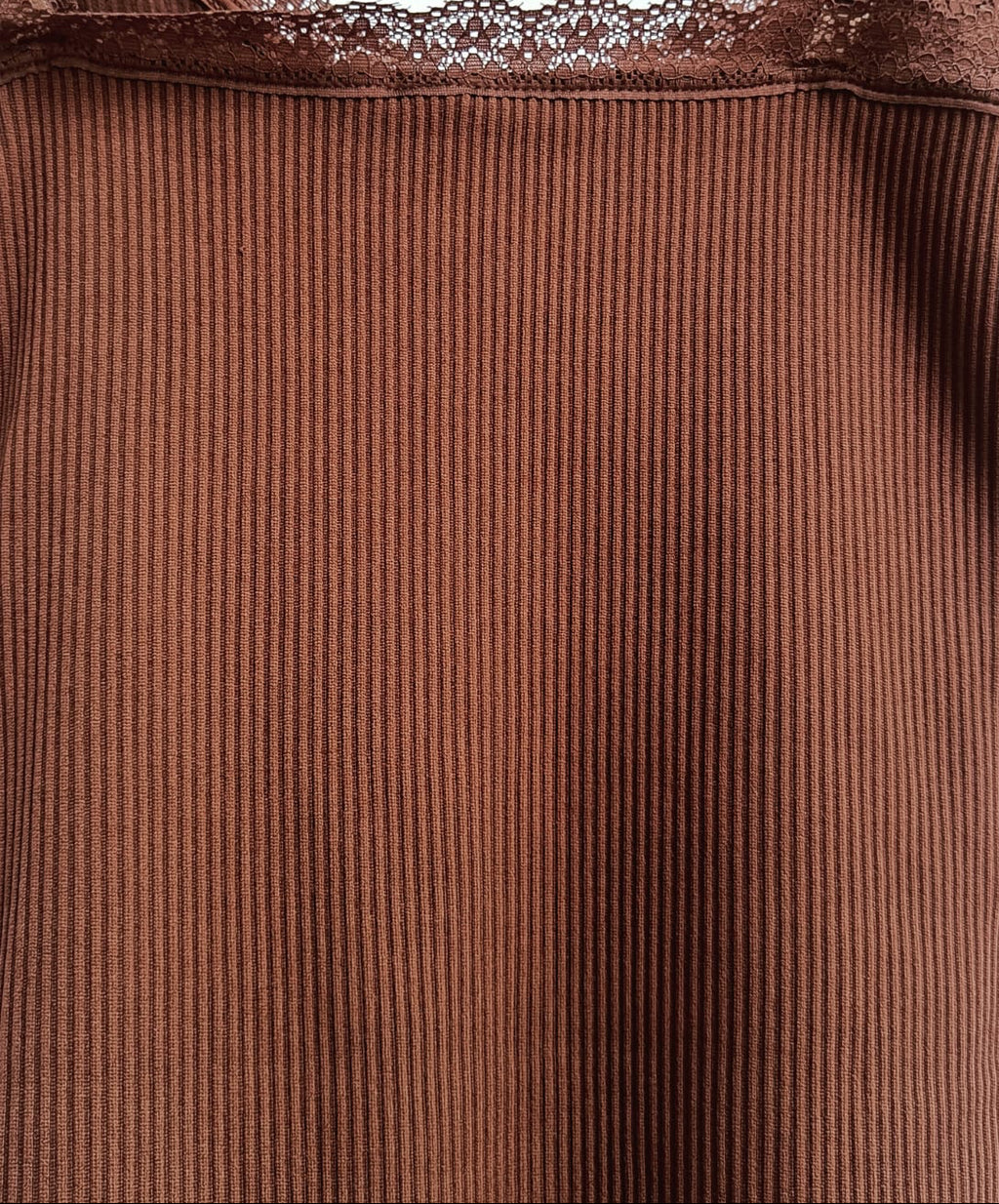 A close-up of a brown ribbed camisole top with delicate lace trim along the neckline and thin shoulder straps, shown against a plain light background.