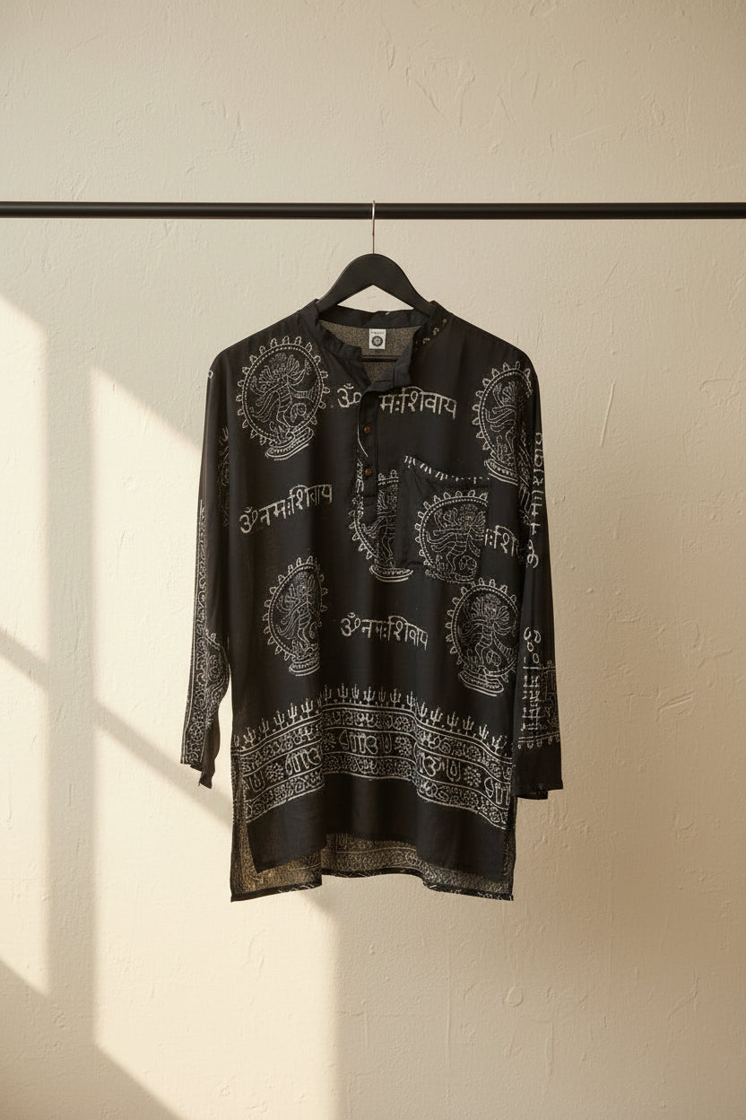 A black long-sleeve tunic top with white printed patterns and Devanagari text, laid flat on a white fabric background.