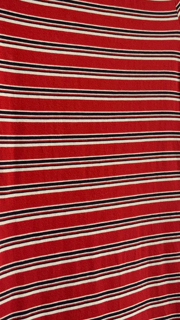 A short-sleeve scoop-neck t-shirt dress with horizontal red, black, and white stripes, hanging on a wooden hanger against a white fabric background.