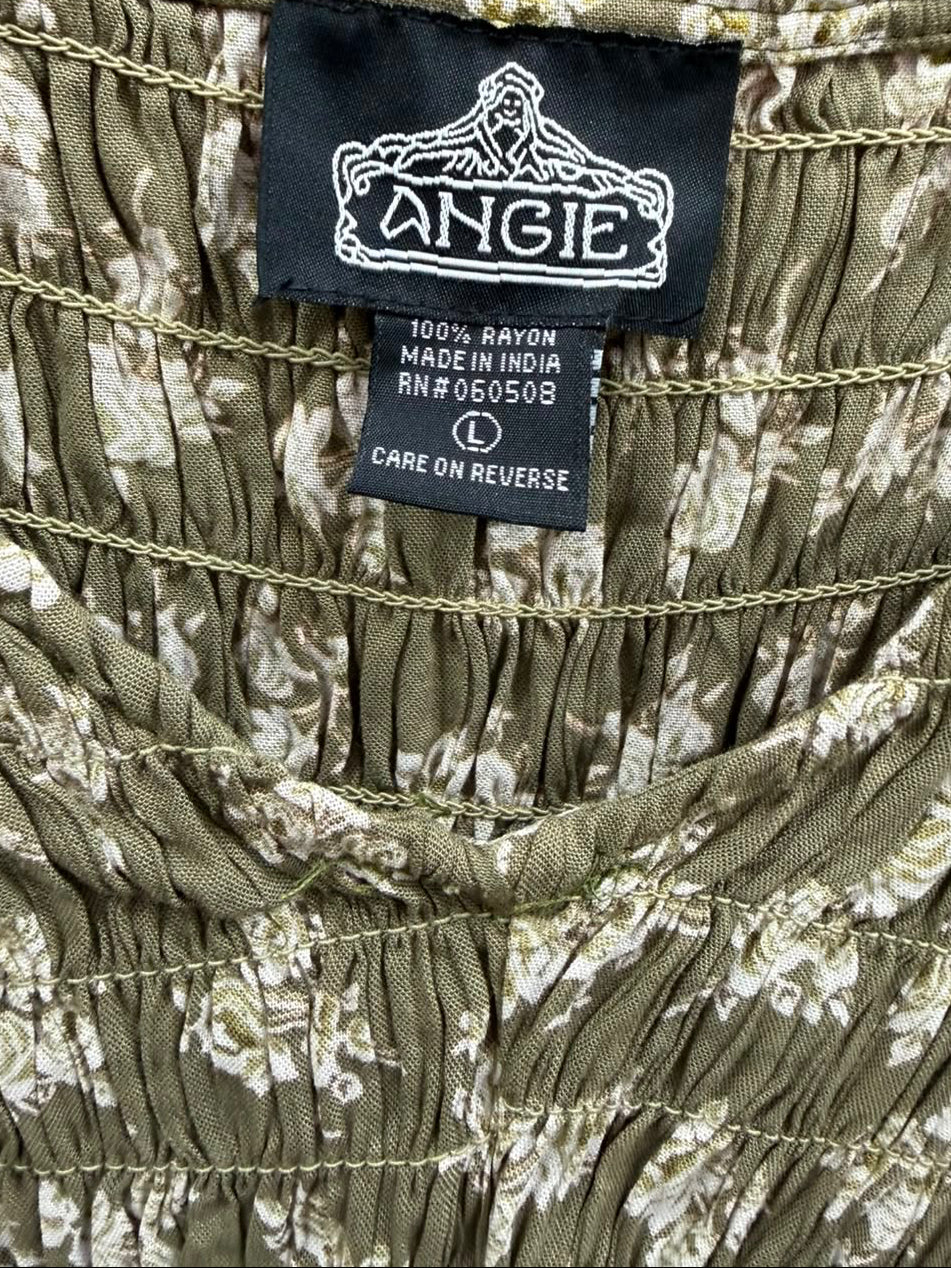 Close-up of a ruched floral garment label reading ANGLIE, showing an olive green fabric with a white floral pattern and a black brand tag.