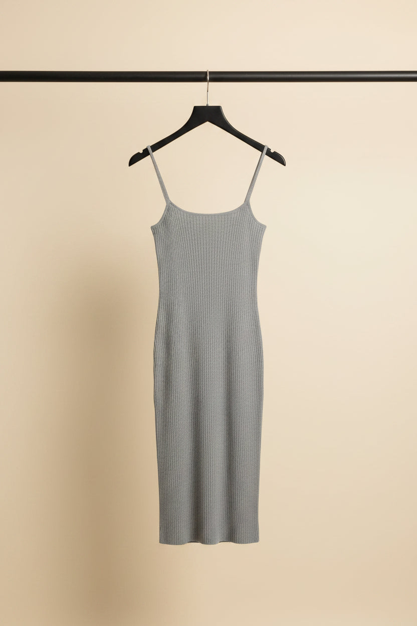 A dark gray ribbed knit spaghetti-strap dress hanging on a wooden hanger 