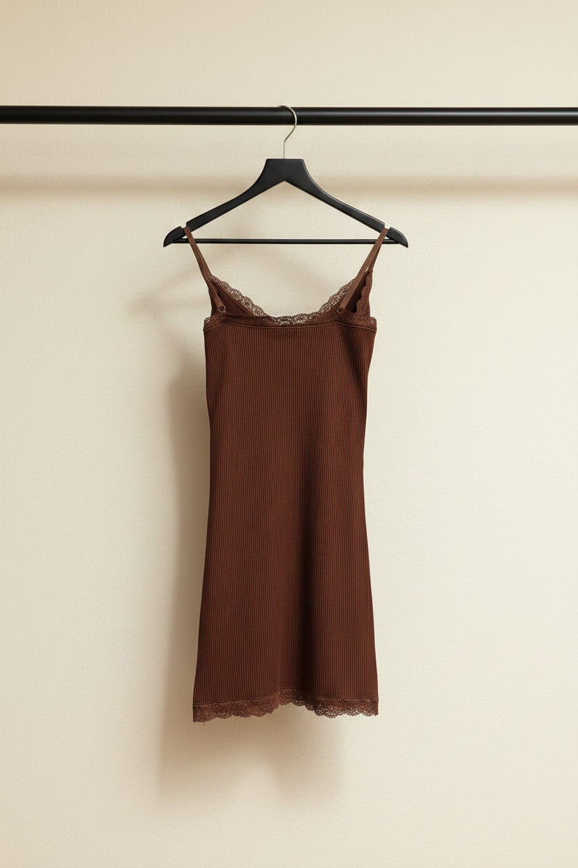 A brown ribbed camisole slip dress with lace trim along the scoop neckline and hem, displayed flat against a white fabric background.