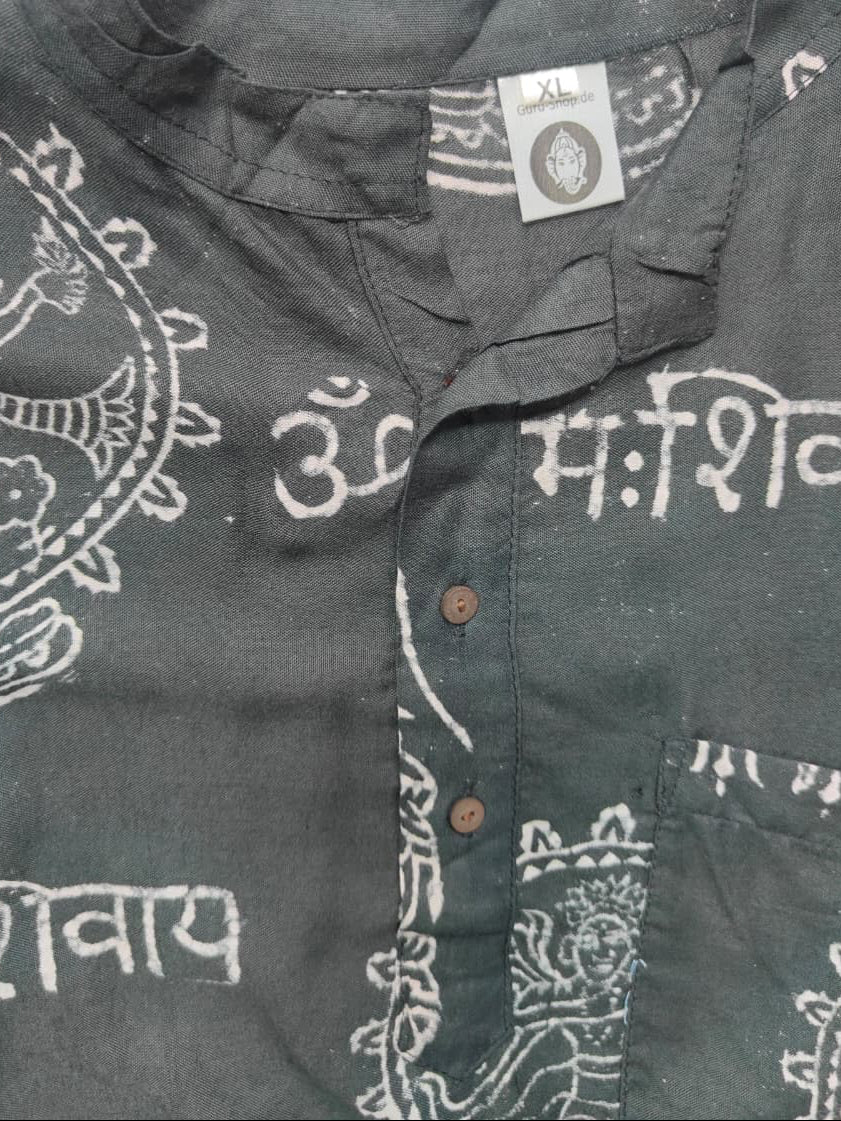 A close-up of a dark gray or charcoal-colored cotton shirt with white block-print style patterns and Devanagari script, featuring a button-down front and a visible size tag.