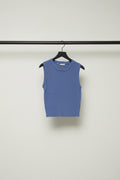 A sleeveless, ribbed knit crop top in a medium periwinkle blue color, laid flat on a light off-white background.