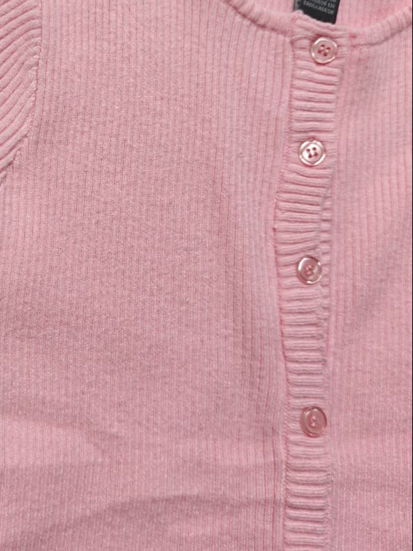 A close-up of a light pink ribbed knit short-sleeve cardigan with a button-up front, laid flat on a light gray background. A black neck label reads 'Love & Lemur'.