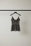 A sleeveless floral print camisole top with thin straps and a ruffled sweetheart neckline, laid flat on a white fabric background.